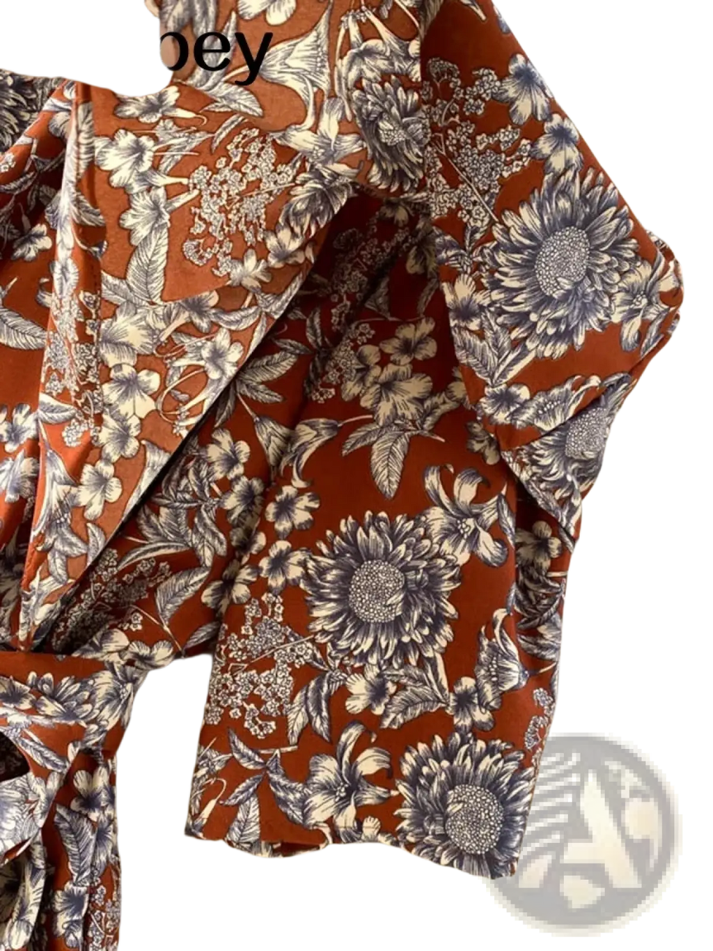 Abebey rust-colored women’s blouse with black and white floral pattern and ruffled sleeves for floral off shoulder wide leg jumpsuit