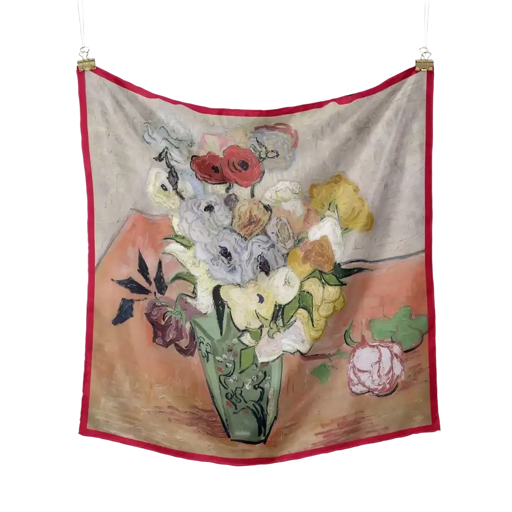 A floral silk square scarf with a vibrant red border featuring an impressionistic pastel floral still life design