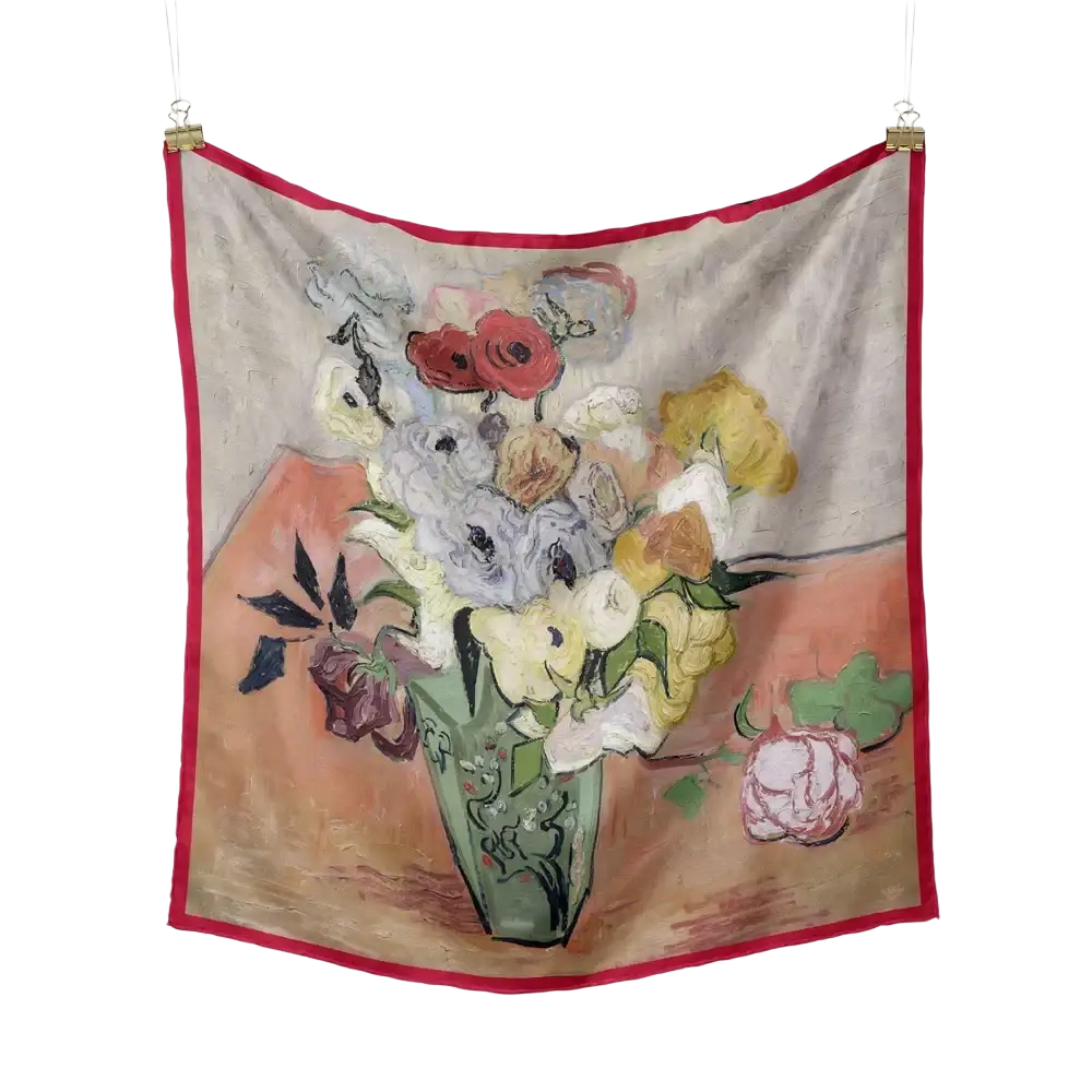 A floral silk square scarf with a vibrant red border featuring an impressionistic pastel floral still life design