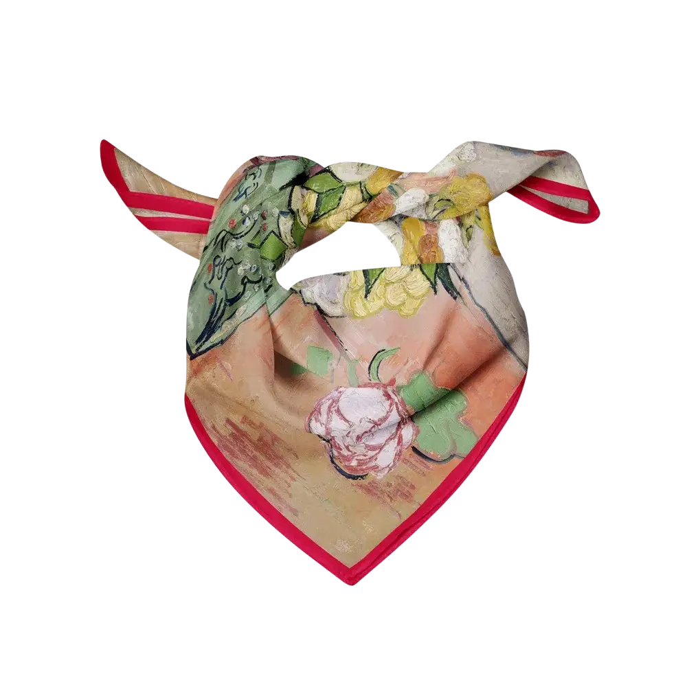 A floral silk square scarf with a vibrant red trim and detailed soft green yellow and pink floral print