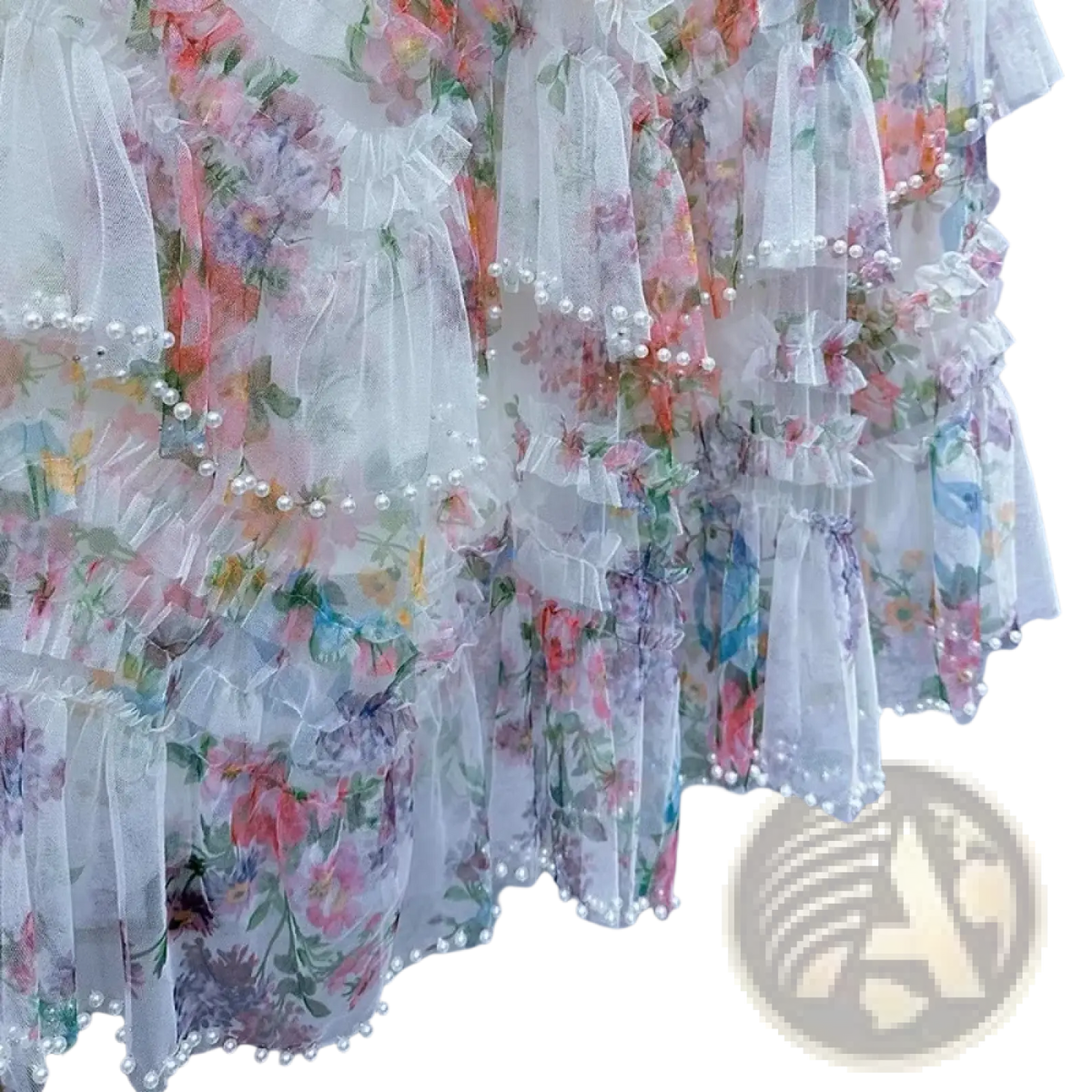 A delicate floral tulle fairycore skirt in sheer white with pastel blossoms and pearl trim along the ruffled hem