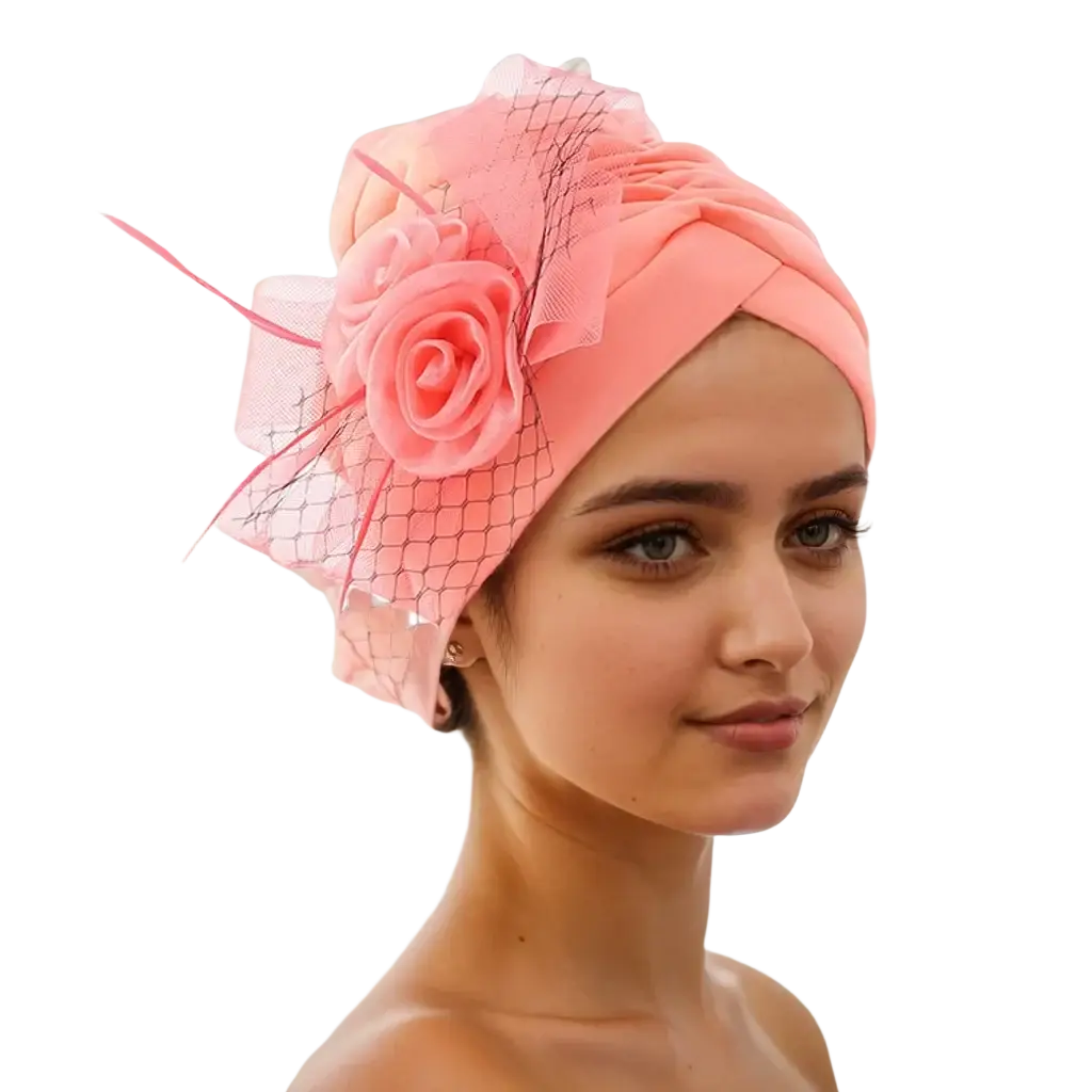 A soft pink velvet floral turban headwrap with a delicate rose and netting, ideal for weddings