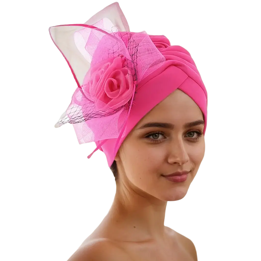 A vibrant pink velvet floral turban headwrap with a fabric rose and sheer mesh accents for wedding wear
