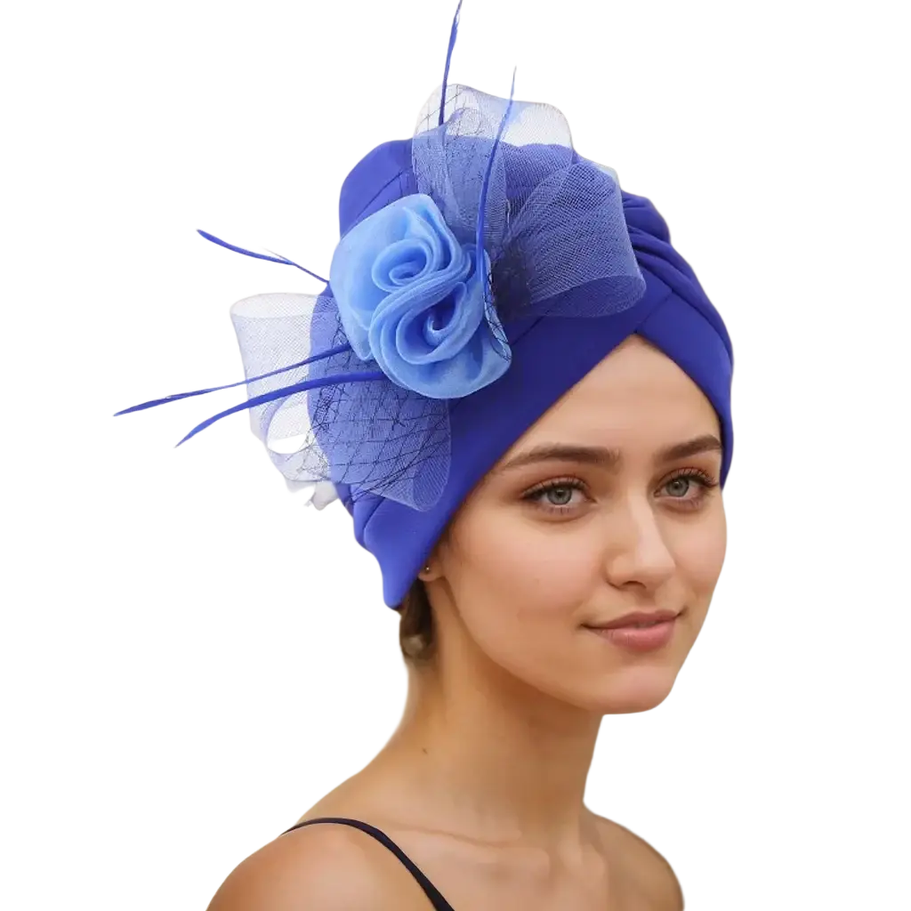 A vibrant royal blue velvet floral turban headwrap with matching fabric rose and sheer mesh accents for weddings