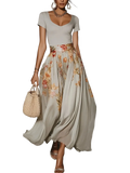 A flowing light gray maxi skirt with vibrant peach and coral floral pattern in a floral two piece midi dress set closure type included