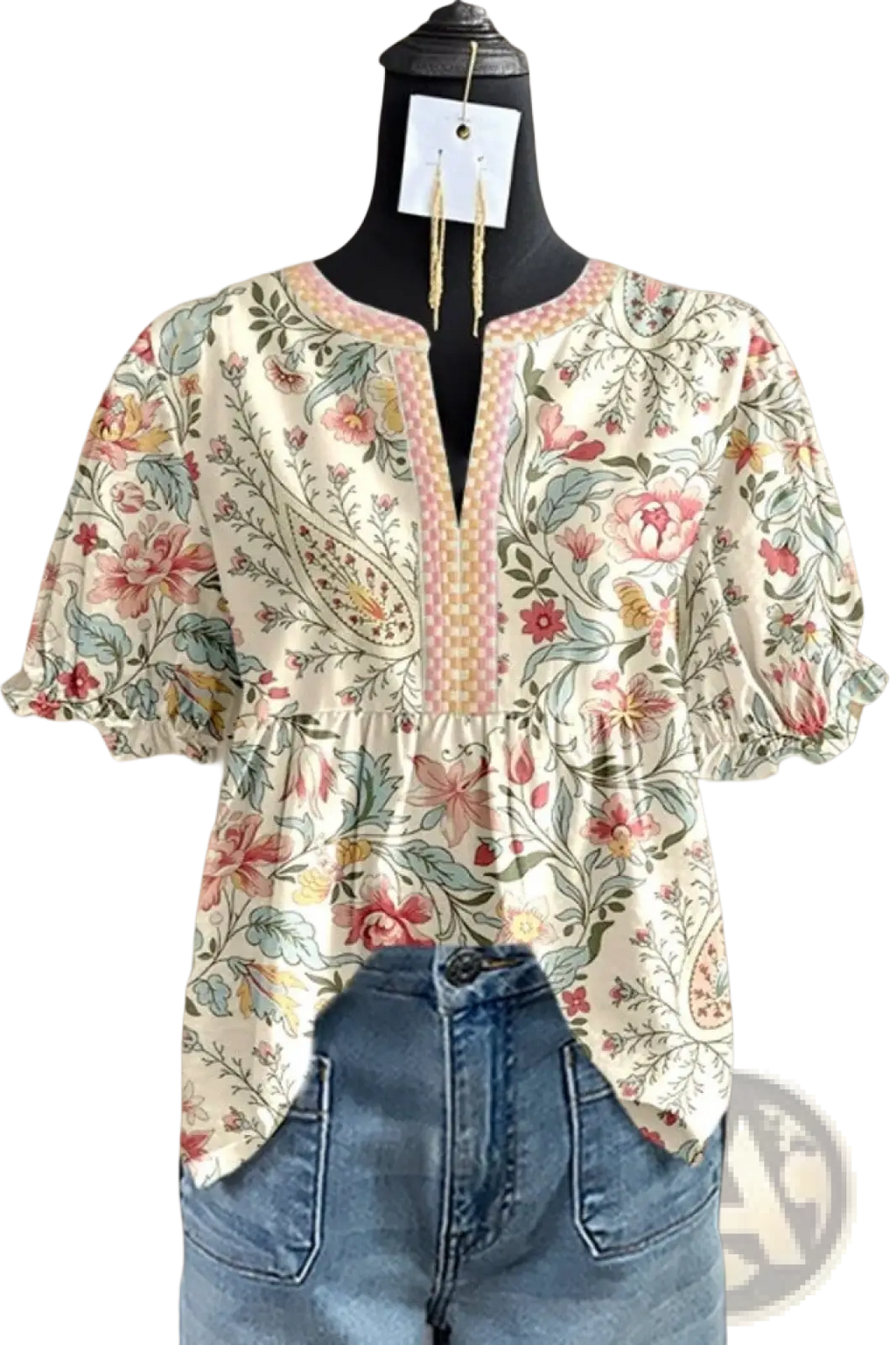 A floral v-neck ruffled sleeve blouse with puff sleeves in soft pastel colors on an off-white background
