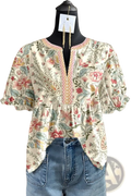 A floral v-neck ruffled sleeve blouse with puff sleeves in soft pastel colors on an off-white background