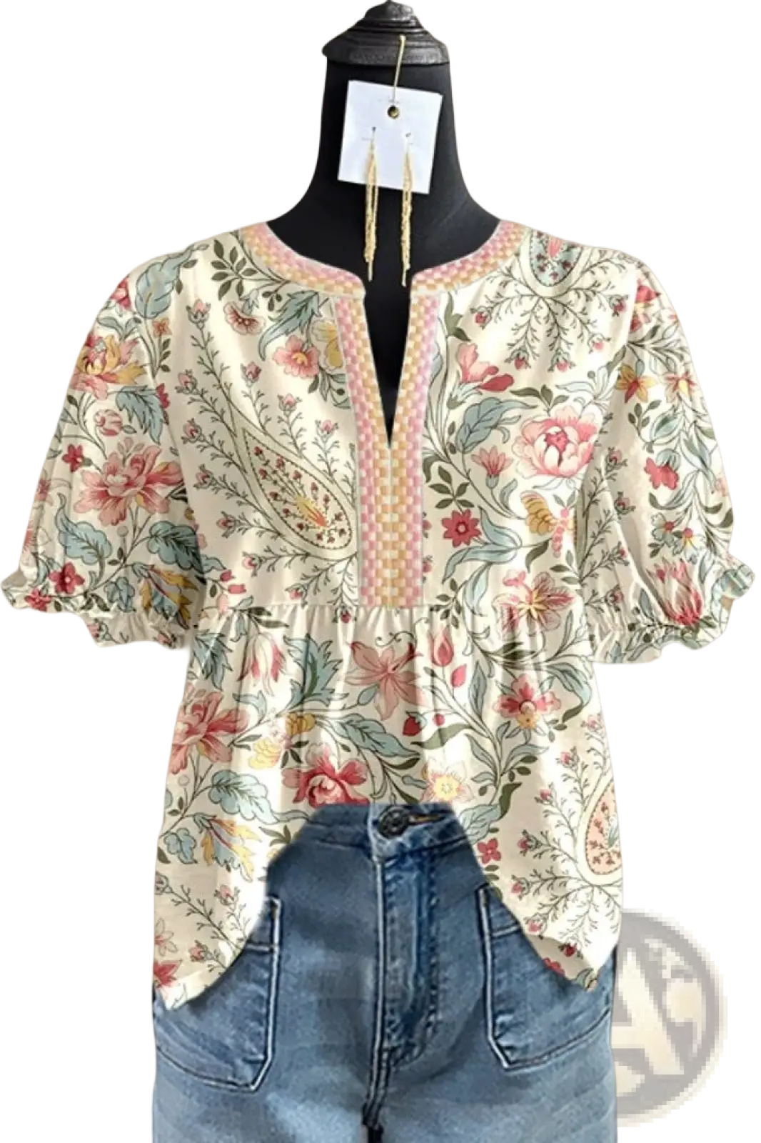 A floral v-neck ruffled sleeve blouse with puff sleeves in soft pastel colors on an off-white background