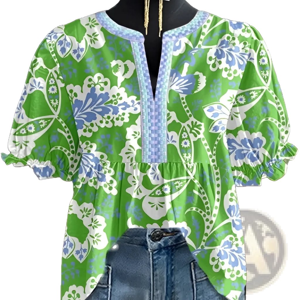 Vibrant green floral v-neck blouse with blue and white patterns and light blue beaded trim on ruffled sleeves