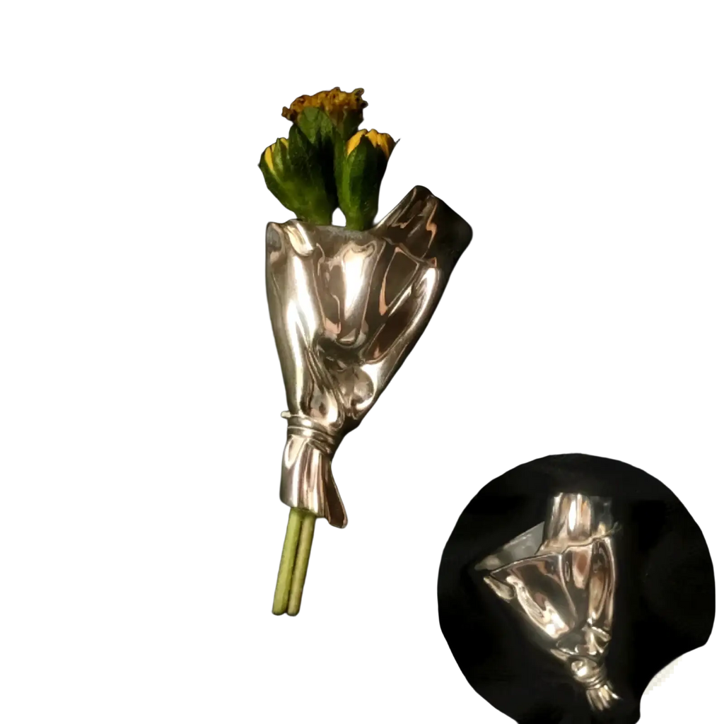 Silver metallic flower brooch pin designed as a hand holding yellow flowers for creative corsage accessory use