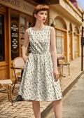 A sleeveless white cotton a-line dress with a black and gray vintage tools botanical print pattern
