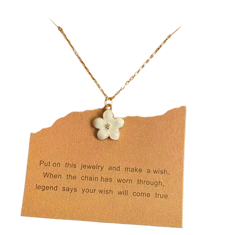 A delicate gold link chain flower pendant necklace with a cute romantic white five-petal flower and clear stone center