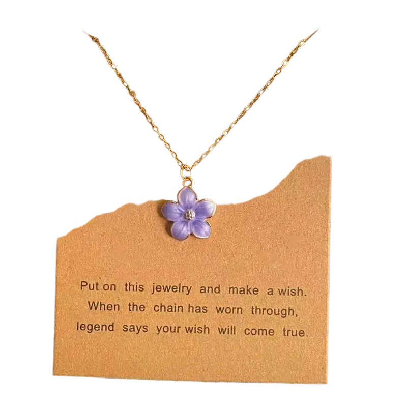 A delicate gold link chain flower pendant necklace with a cute romantic purple enamel flower and clear gemstone center