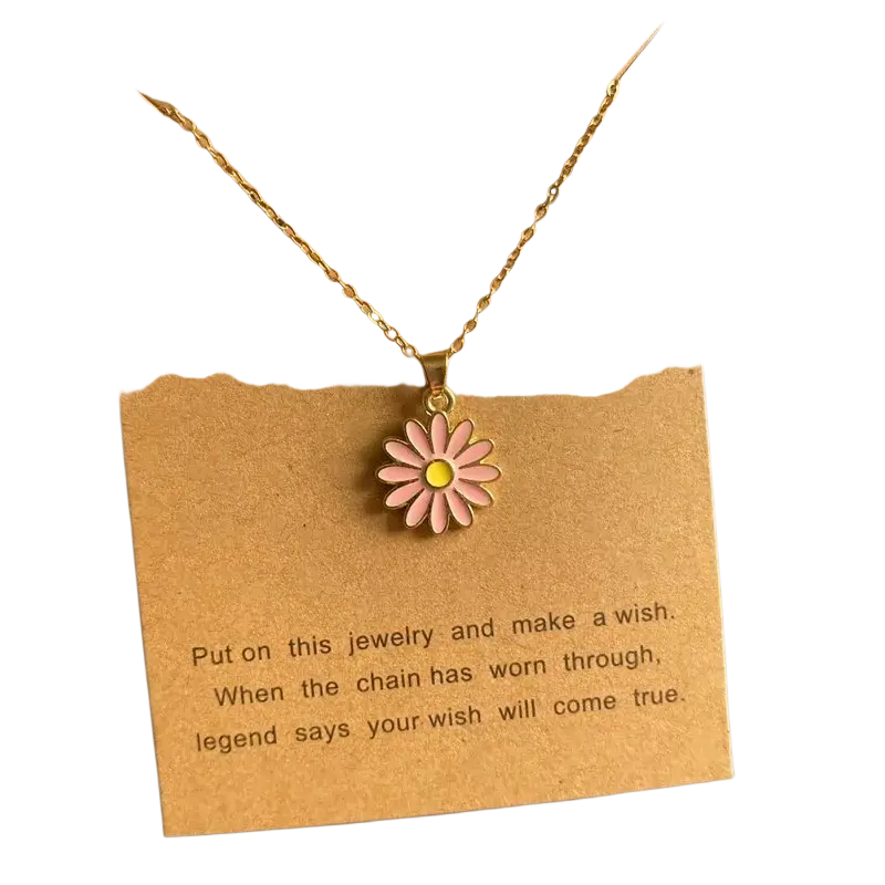 Delicate gold-toned link chain flower pendant necklace with pink enamel daisy for a cute romantic look displayed on brown card