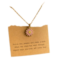 Delicate gold-toned link chain flower pendant necklace with pink enamel daisy for a cute romantic look displayed on brown card