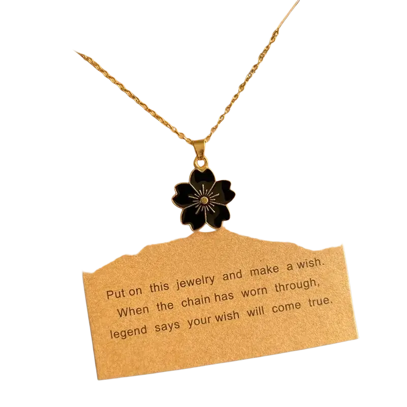 Gold-toned link chain flower pendant necklace with cute romantic black enamel cherry blossom and gold center detail