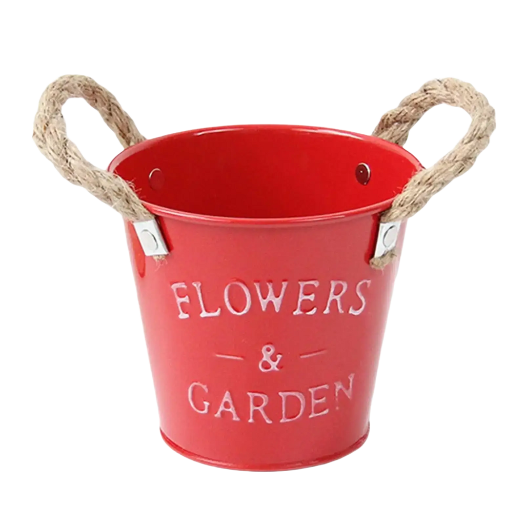 Red metal flower pot with rope handles and flowers and garden embossed for rustic farmhouse garden plant flowers