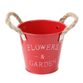 Red metal flower pot with rope handles and flowers and garden embossed for rustic farmhouse garden plant flowers