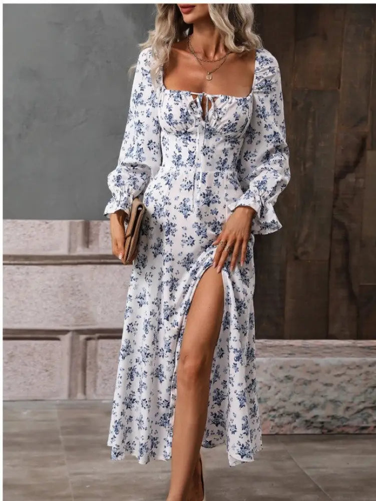 White floral midi dress with long sleeves and square neckline featuring delicate blue blossoms across fabric