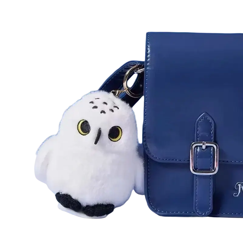 Fluffy white owl plush toy keychain with yellow eyes black beak and soft fluffy texture