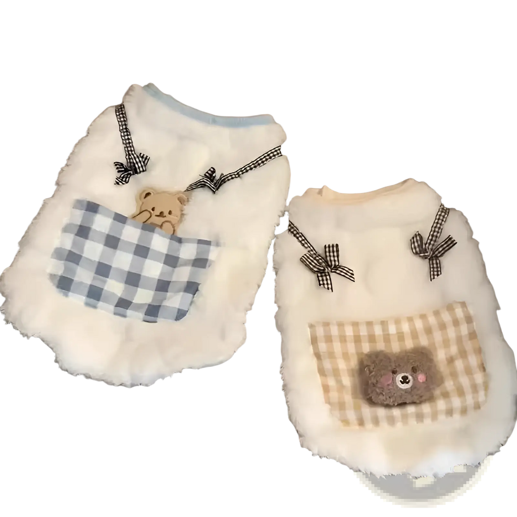 White fluffy winter cat vest with blue and white checkered pocket and tan bear appliqué with gingham ribbon ties