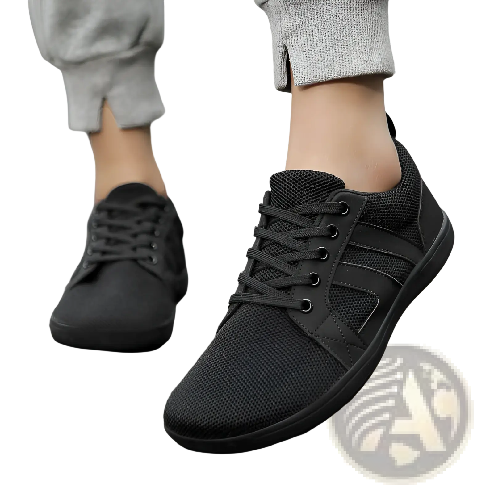 Black fly-knit wide last sneakers with breathable mesh material and black laces in a sleek minimalist design