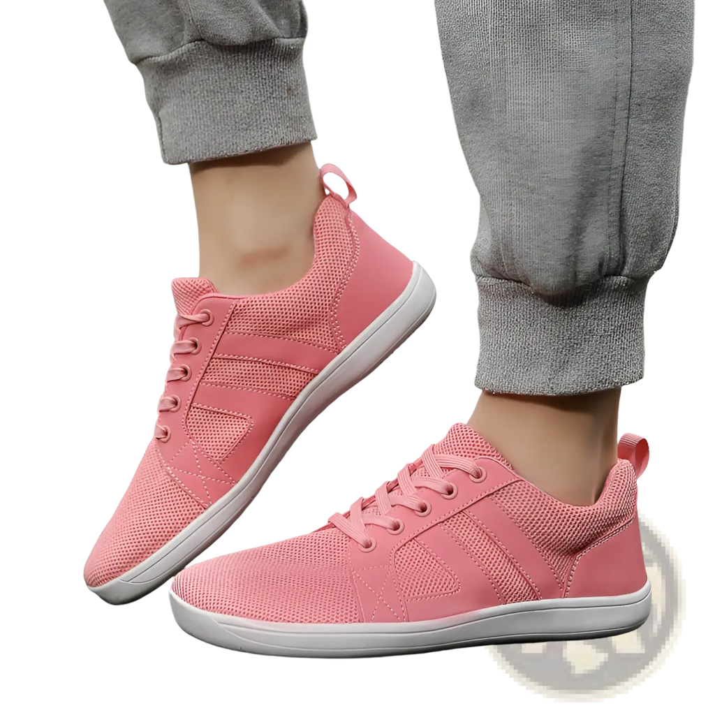 Pink fly-knit wide last breathable mesh sneakers with white soles and matching laces for comfortable wear