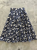 A navy blue retro pleated doris a-line skirt with white flying ghost pattern and pockets