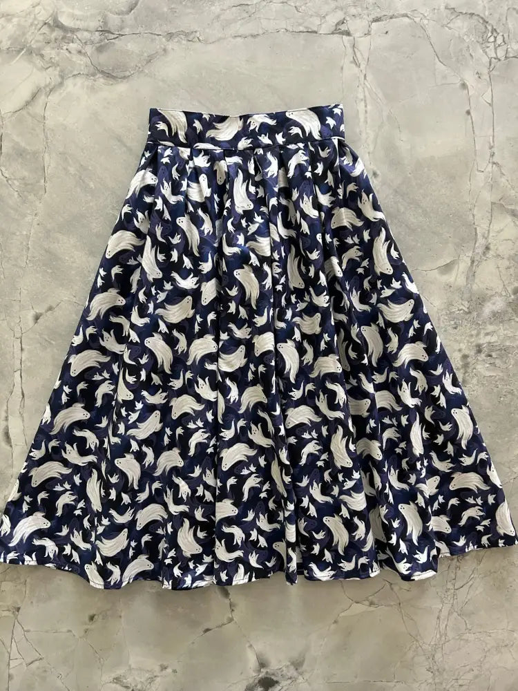A navy blue retro pleated doris a-line skirt with white flying ghost pattern and pockets