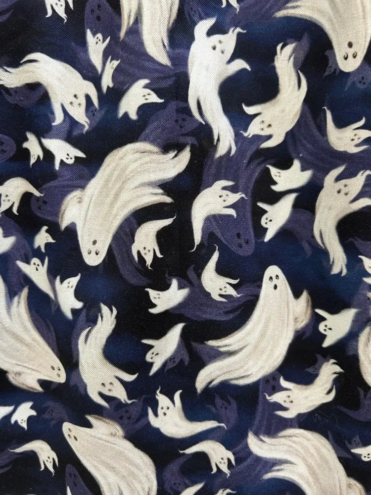 Dark blue cotton fit and flare dress featuring a repeating pattern of whimsical white translucent ghosts
