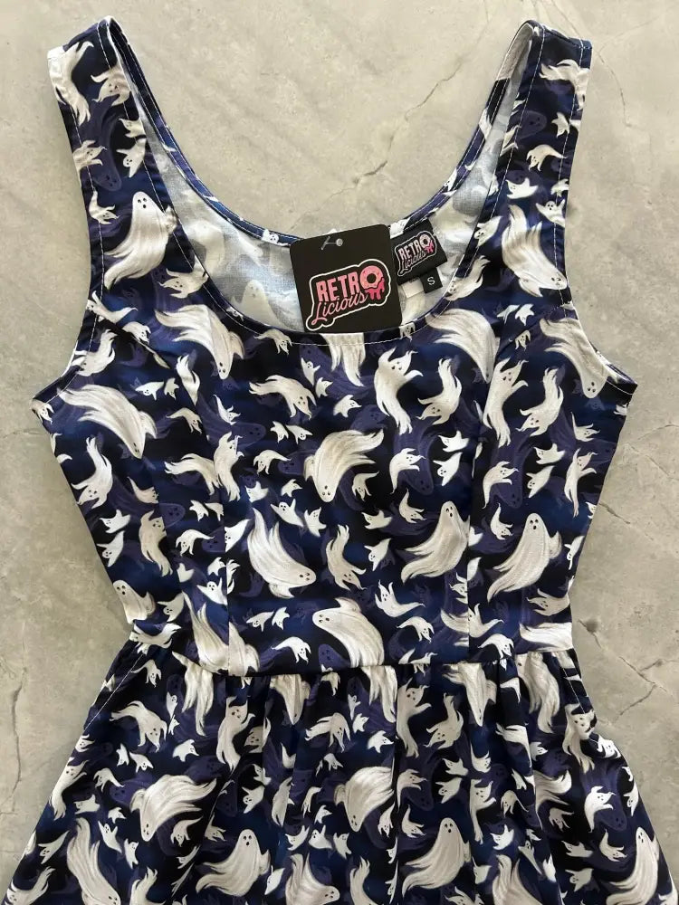 A navy cotton fit and flare sleeveless dress with a playful white flying ghosts pattern