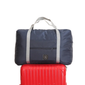 Navy blue foldable canvas travel bag set with gray reinforced handles and small black logo patch for easy portability