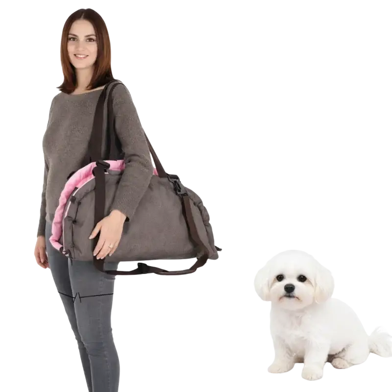 Gray fabric foldable pet carrier bed with pink lining and adjustable strap featuring safety leash clip for secure travel