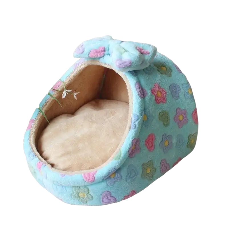 Foldable plush pet cave bed for small dogs and cats in light blue with colorful floral patterns and a matching bow