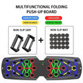 Foldable push up board training system in black with colorful circular grip points and non-slip mat attachments
