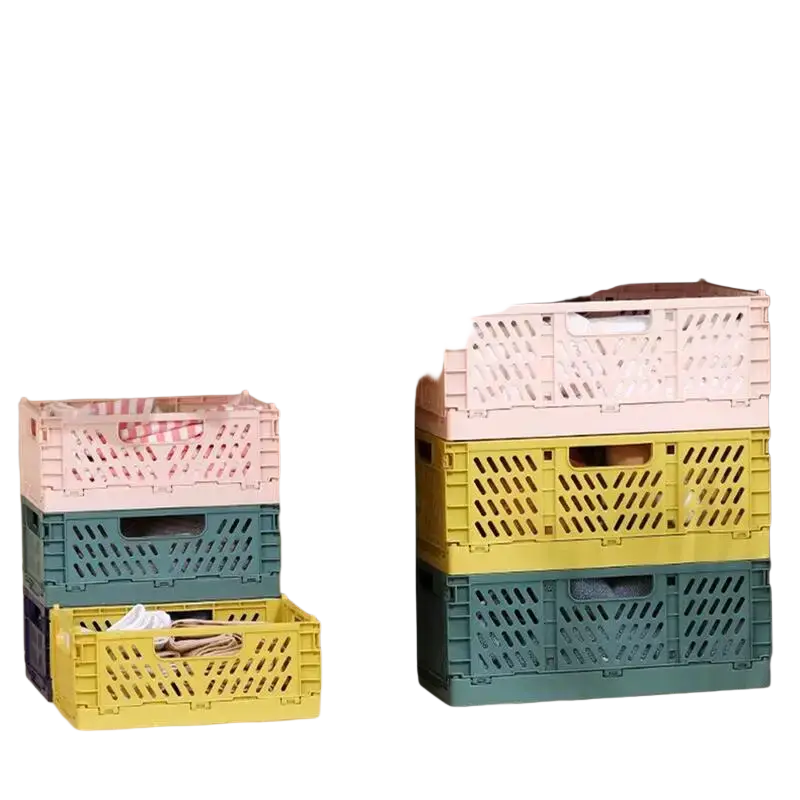 Stacked pastel-colored foldable storage baskets made of plastic with lattice pattern and handle cutouts in pink