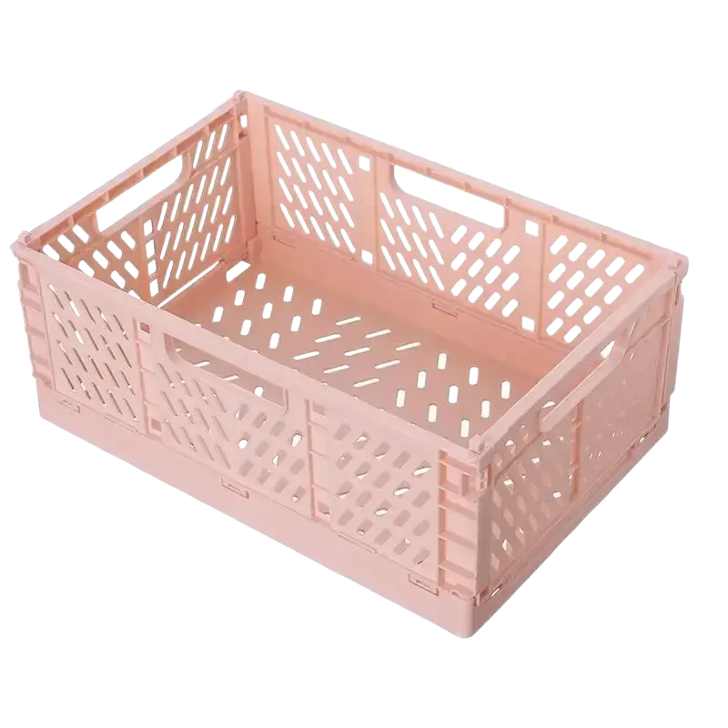 A pink foldable storage basket made of plastic with lattice pattern and integrated handles for easy stacking and storage
