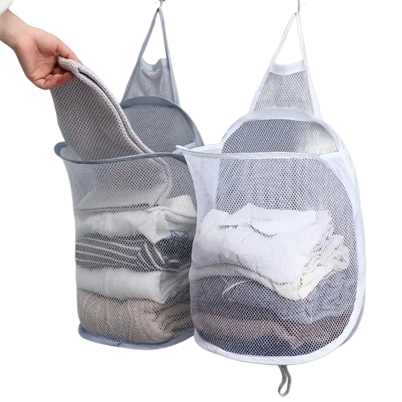 White foldable storage laundry basket made of mesh with reinforced edges and hanging hooks for wall mounted use