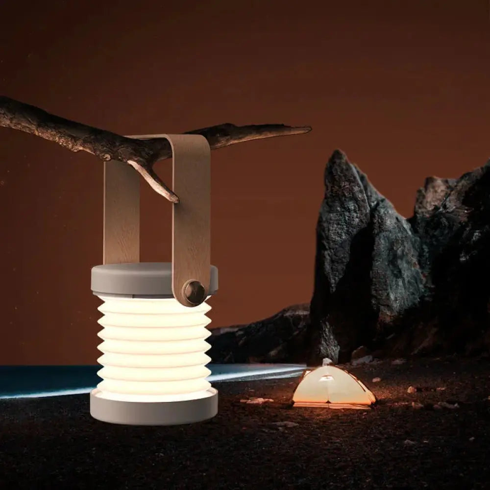 A sleek white foldable touch dimmable led lantern with minimalist design and leather-like handle for portability