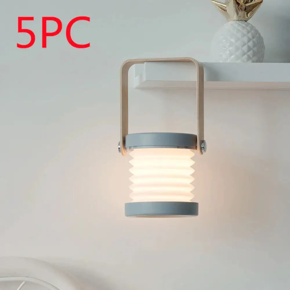 Gray foldable touch dimmable led lantern with metallic handle emitting warm light for portable table lamp use