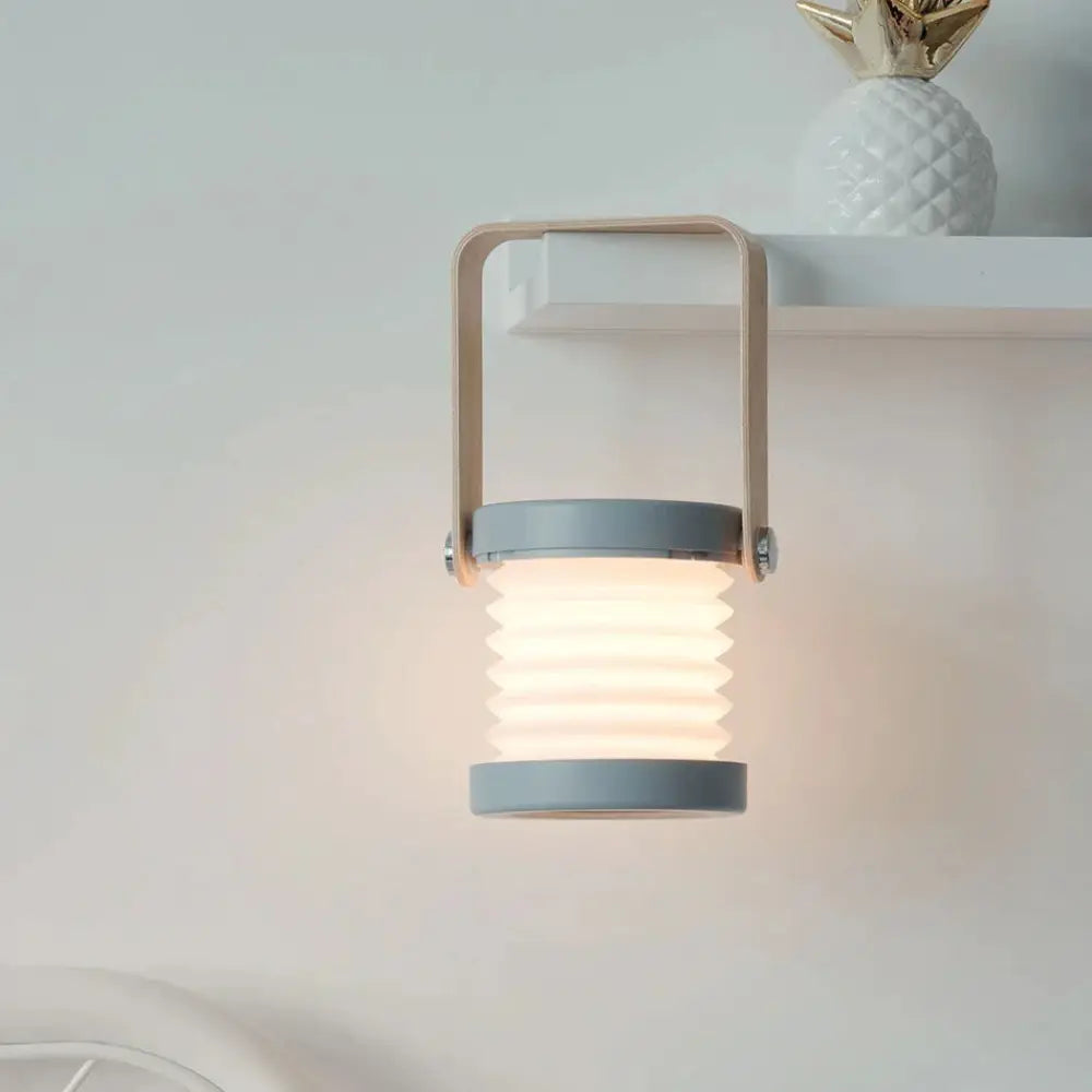 Gray collapsible lantern-style wall sconce with metallic handle foldable touch dimmable led lantern and portable table lamp