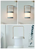 Minimalist white foldable touch dimmable led lantern with brass handle and gray accents for modern interior lighting