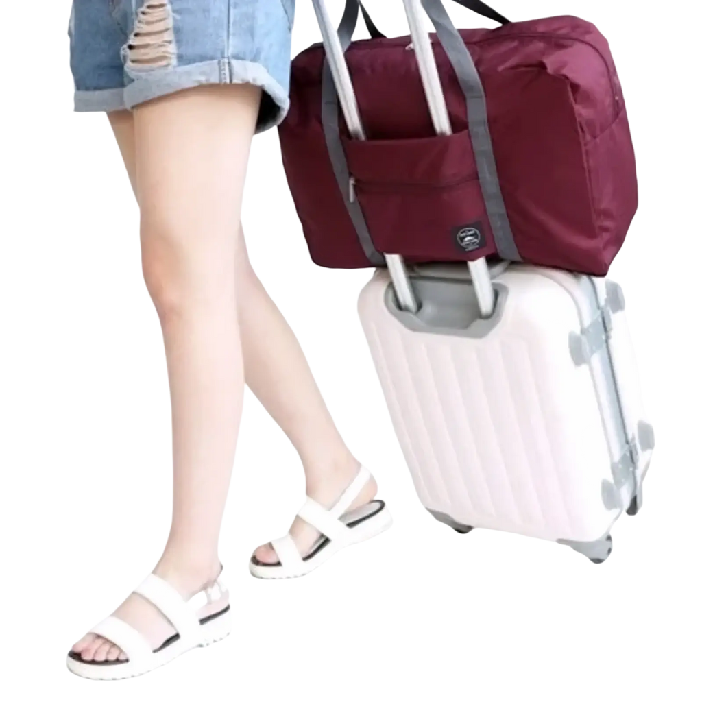 Maroon foldable travel duffel bag with gray straps and logo designed to attach over rolling suitcase handle for women luggage