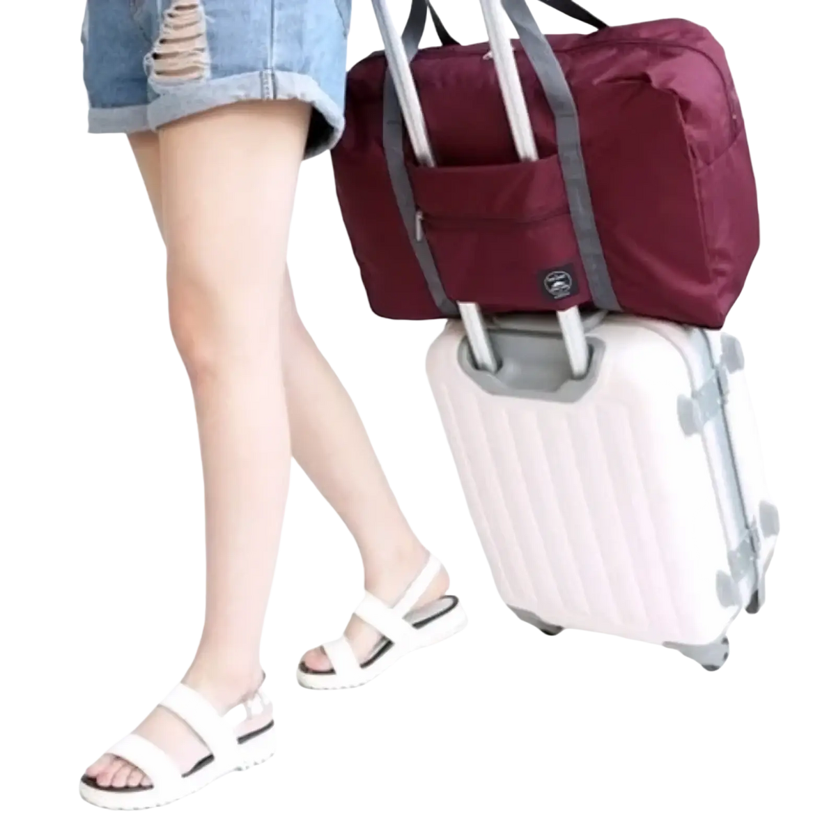 Maroon foldable travel duffel bag with gray straps and logo designed to attach over rolling suitcase handle for women luggage