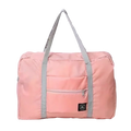 Foldable travel duffel bag large women luggage in pink with gray straps and front zippered pocket for easy packing