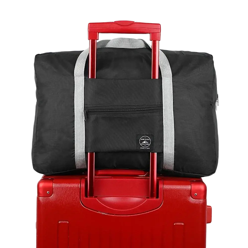 Black foldable travel duffel bag with red retractable handle and gray striped straps for waterproof luggage use