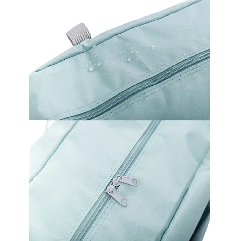 Light blue foldable travel duffel bag made of waterproof fabric with silver zipper pulls and gray strap tab