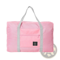 Pink foldable waterproof travel duffel bag with gray handles front zippered pocket and black brand patch