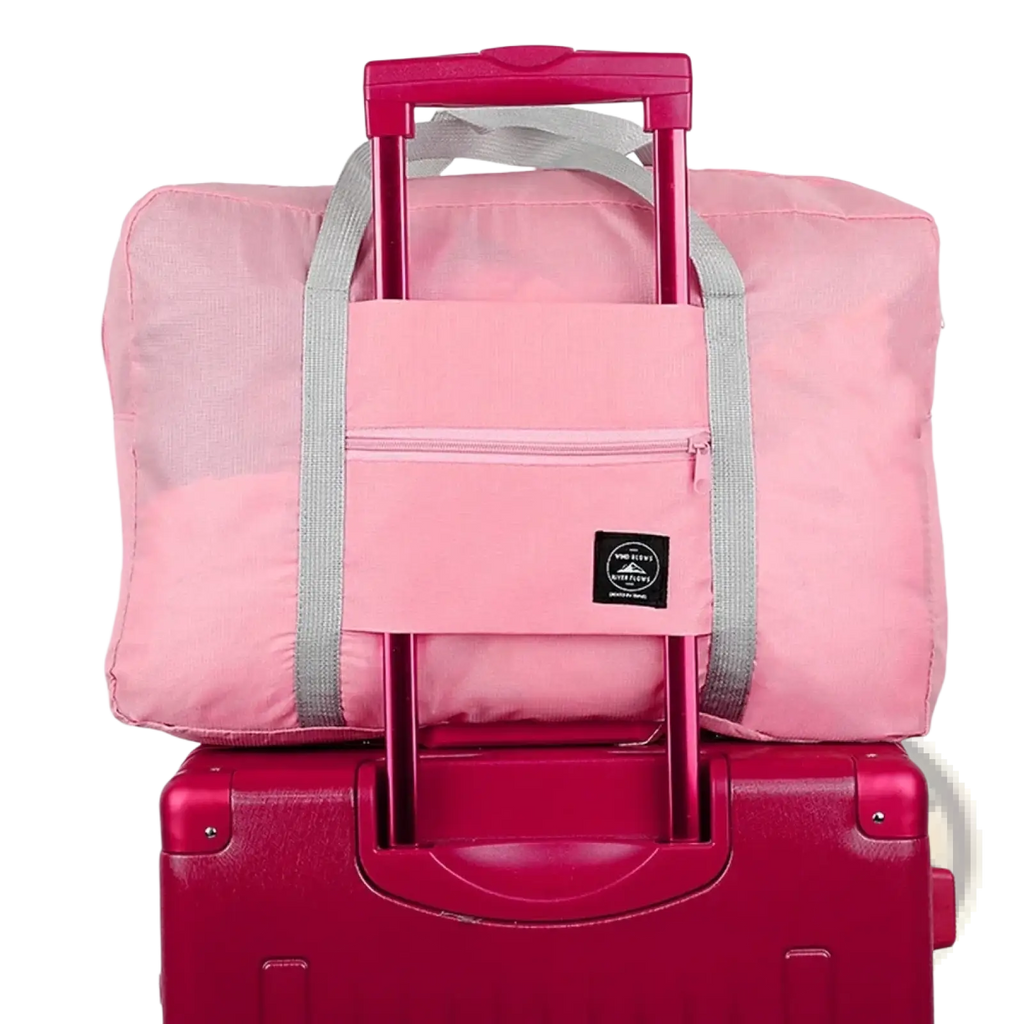 Pink foldable travel duffel bag with gray straps retractable handle front zippered pocket waterproof luggage tote