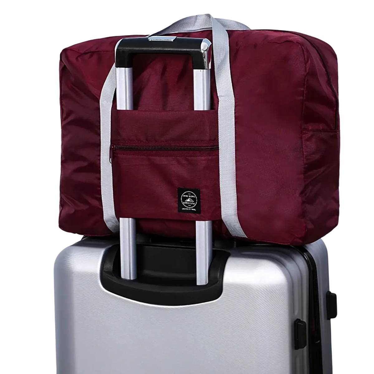 Maroon foldable travel duffle bag with silver handle and straps made of lightweight nylon with front zippered pocket